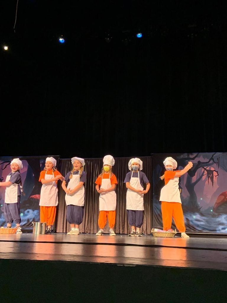 Students performing on stage.